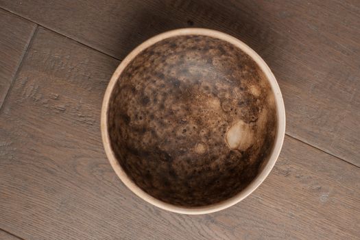 Traditional handcrafted dish of brown color on the table