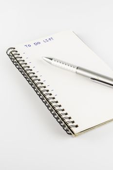 notebook with pen write to do list word on a white back ground