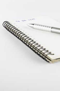 notebook with pen write to do list word on a white back ground