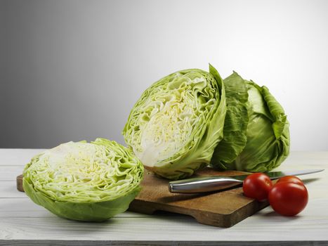 fresh ripe cabbage and tomato on cutting board
