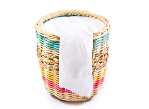 close up of white toilet paper in colorful box on white background