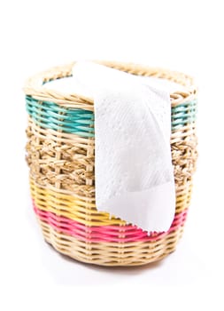 close up of white toilet paper in colorful box on white background