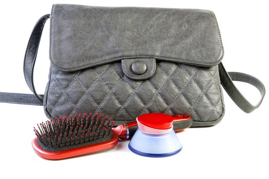 Female bag and cosmetics isolated on a white background