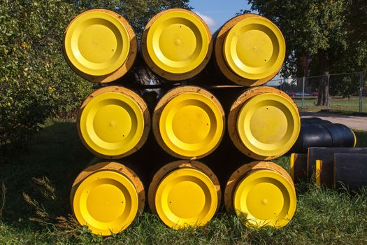 A bunch of yellow and black pipes stacked together