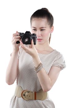 Young woman photographer taking pictures with film camera, isolated on white.