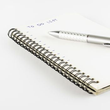 notebook with pen write to do list word on a white back ground