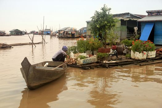 SIEM REAP, CAMBODIA - APRIL 06, 2014: An unidentified woman on a floating village on Tonle Sap lake in Siem Reap, Cambodia on April 06, 2014. 