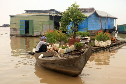 SIEM REAP, CAMBODIA - APRIL 06, 2014: An unidentified woman on a floating village on Tonle Sap lake in Siem Reap, Cambodia on April 06, 2014. 