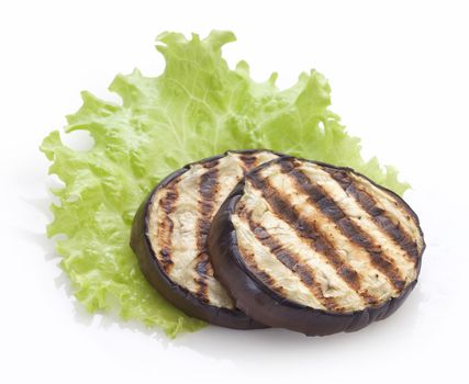 Some fried slices of eggplant with fresh green lettuce on the white