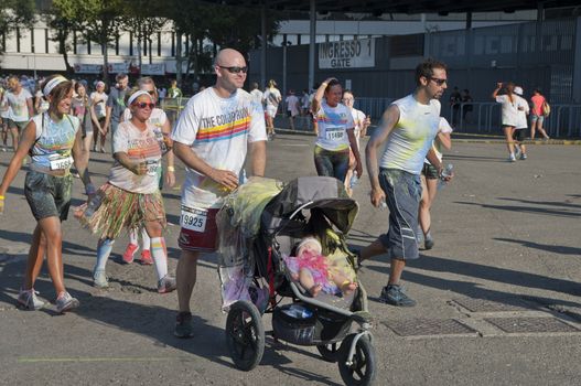 Different ages participants in the Color Run marathon. Milan, Italy