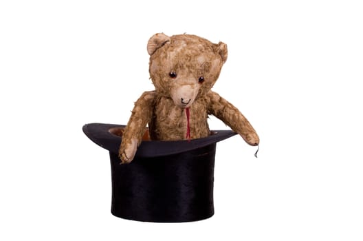 old teddybear sitting in old black hat