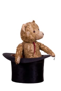 old teddybear sitting in old black hat