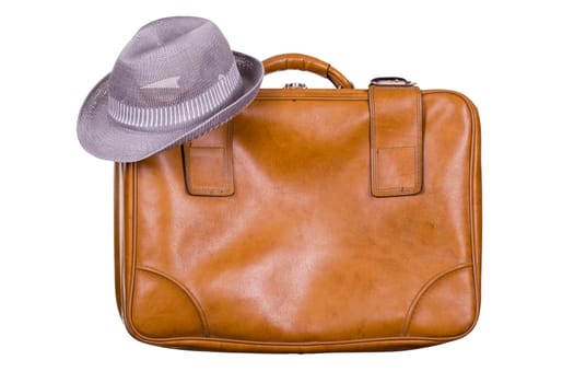 brown suitcase with hat