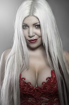 Beautiful woman with white hair red corset scales