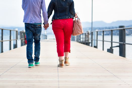 Opposites Attract - Quite disproportionate young couple walking on a jetty