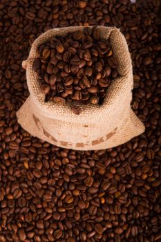 Burlap sack of coffee beans on the coffee beans background