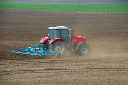 Tractor plowing the agicultural fields