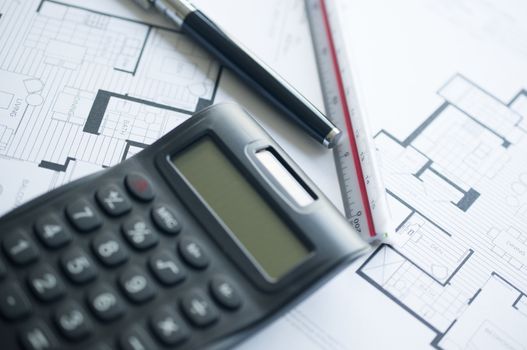 Architect with calculator and plan, pencil and ruler 