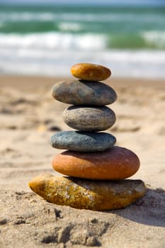 A composition of stacked stones on the beach.