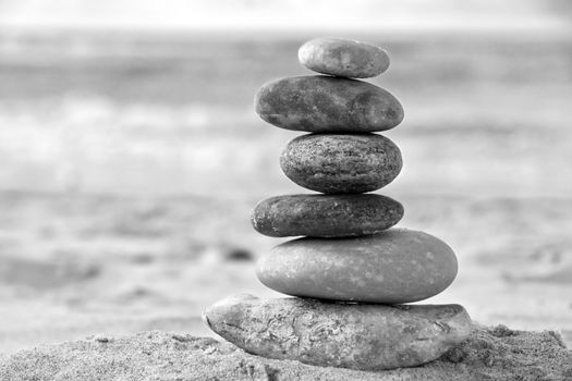 A composition of stacked stones on the beach.