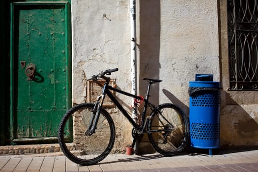 old bicycle near the ancient walls and doors