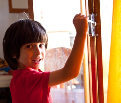 smiling boy opens the door of a new home