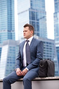 young businessman on background of office center