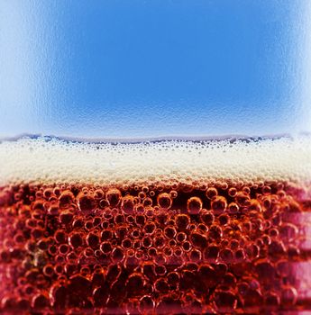 cola with bubbles and foam close up