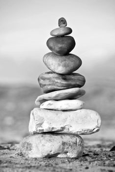 A composition of stacked stones on the beach.