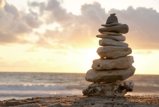 A composition of stacked stones on the beach.