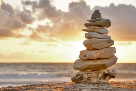 A composition of stacked stones on the beach.