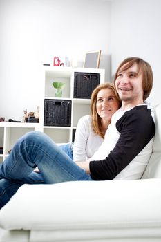 Happy couple relaxing in living room