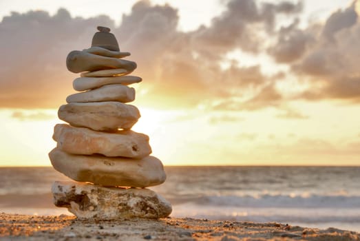 A composition of stacked stones on the beach.