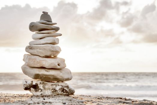 A composition of stacked stones on the beach.