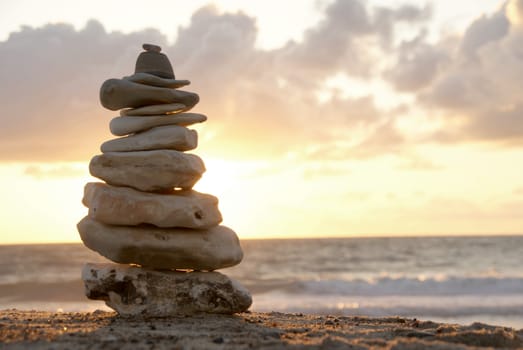 A composition of stacked stones on the beach.