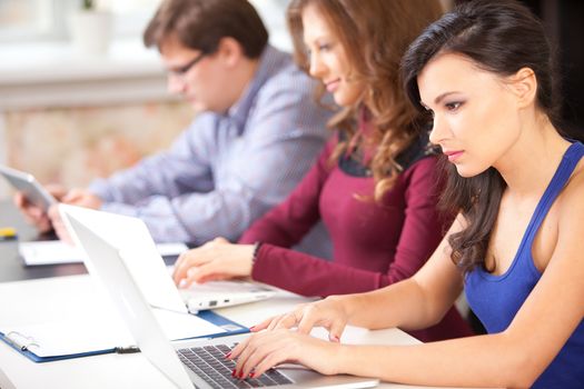 Group of students using a laptop computer