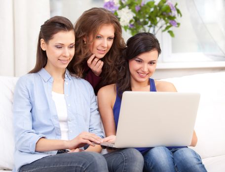 Group of students using a laptop computer 