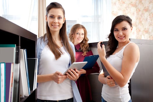 Group of happy students in a library