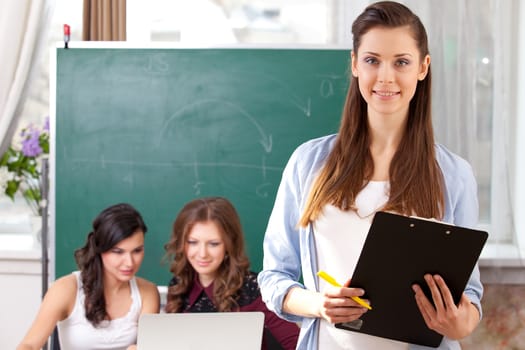 Portrait of smiling pretty girl looking at camera in college