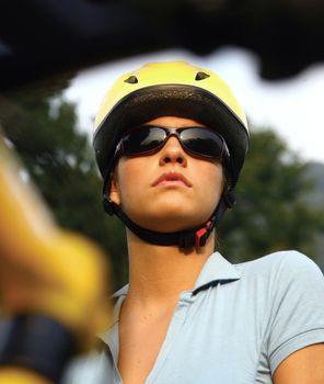 portrait of a young female in a cycling helmet looking concerned - intentional shallow depth of field