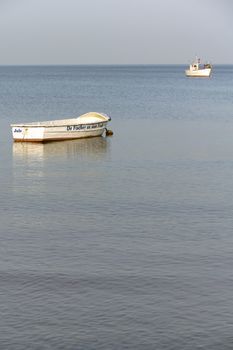 Fishing boats in the shallow sea anchor.