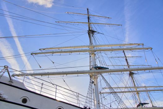 The large mast of an old sailing ship.