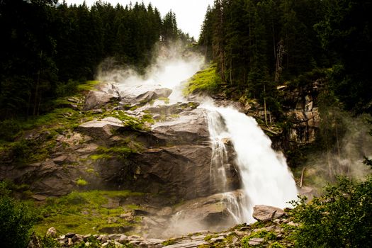 Very strong waterfall in high Alps mountains