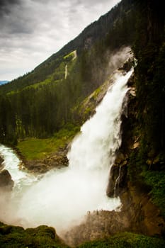 Very strong waterfall in high Alps mountains