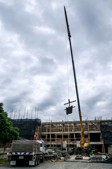 Crane hoist concrete plate at construction site