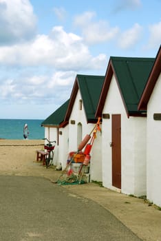 White fishing huts at a beach in Denmark.
