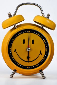 yellow alarm clock-emoticon on a white background