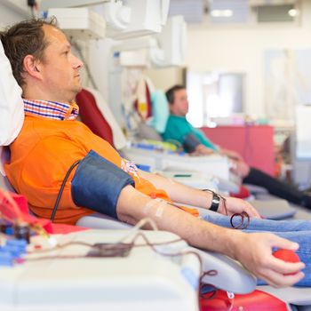 Blood donor at donation with a bouncy ball holding in hand.