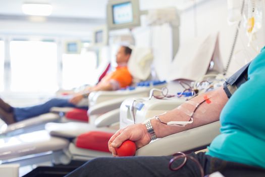 Blood donor at donation with a bouncy ball holding in hand.