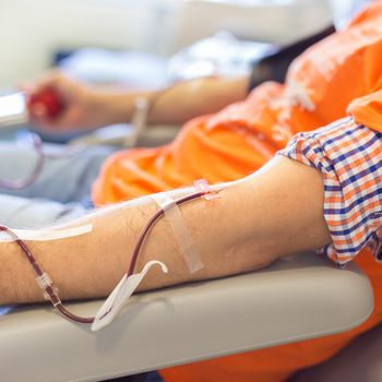 Blood donor at donation with a bouncy ball holding in hand.